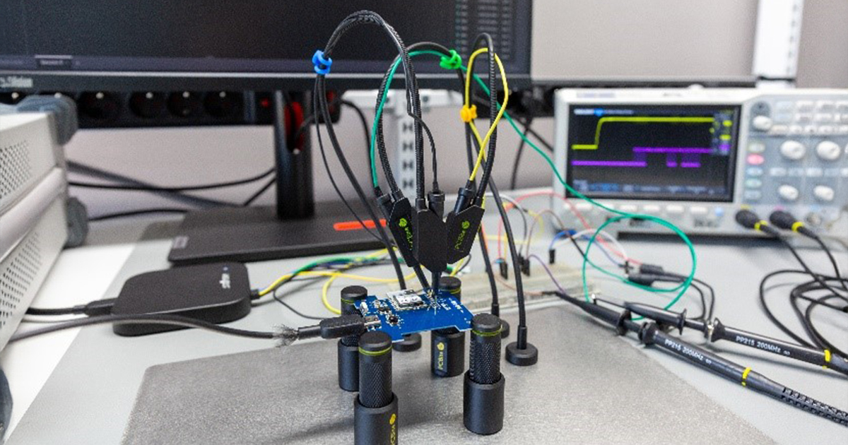 The photo shows a laboratory setup for testing an electronic board